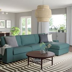 a living room filled with furniture and a rug on top of a hard wood floor