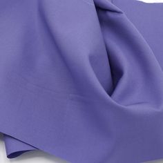 the purple fabric is folded on top of each other