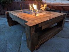 a fire pit sitting on top of a wooden table