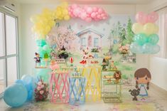 a room filled with balloons and decorations on the wall next to a table full of food