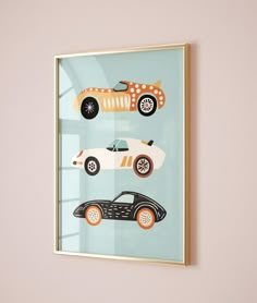 a framed art print with cars on it's side hanging on a wall in a room