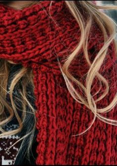 a woman with blonde hair wearing a red scarf