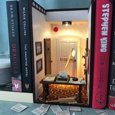 a room with several books on the wall and a desk in the doorway between them