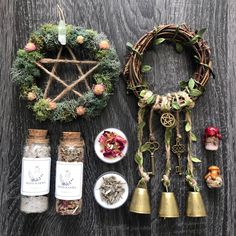 various items are arranged on a table including bells, herbs and other things to decorate