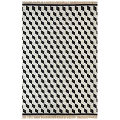 a black and white rug with small squares on the front, fringes at the bottom