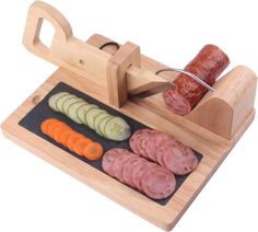 a wooden cutting board with sliced vegetables and meats on it, next to a sausage slicer