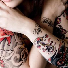 a woman with lots of tattoos on her arm and chest is posing for the camera