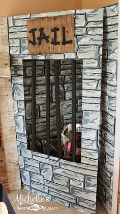 the jail cell is made out of wood and paper machs with writing on it