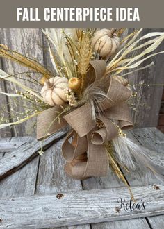 a fall centerpiece idea with wheat, pumpkins and burlocks on it