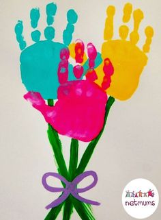 handprints made to look like flowers in a vase with purple ribbon on the bottom