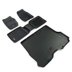 four pieces of black rubber floor mats