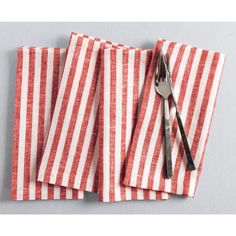 four red and white striped napkins with forks