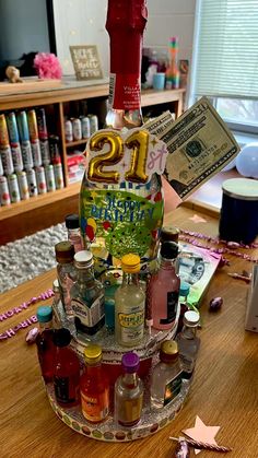 a number twenty bottle on top of a wooden table with confetti and candy