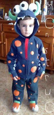 a young boy wearing a monster costume standing in front of a kitchen counter with the words don't sit out on it