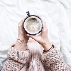 a woman holding a cup with the words poshmark over her face and hands