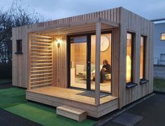 a small wooden building with a person sitting in it