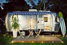 an airstream is lit up at night with lights