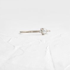 4mm rose cut white diamond (SI clarity) SI clarity white diamonds (1mm -1.5mm) Solid 14k gold setting with a delicate 1.2mm round band (available in yellow, rose, or white gold) Total carat weight: .18ct. We handcraft each piece with responsibly sourced 14k gold and ethically sourced stones. Classic White Gold Diamond Ring, Everyday Diamond Stackable Rings With Round Cut, Dainty Diamond White Stackable Rings With Single Cut Diamonds, Everyday Stackable Rose Cut Diamond Rings, Timeless Sterling Silver Diamond Ring With Rose Cut, Delicate White Gold Diamond Ring With Single Cut Diamonds, Dainty Sterling Silver Diamond Ring With Rose Cut, White Minimalist Diamond Ring With Single Cut Diamonds, Minimalist White Diamond Ring With Single Cut Diamonds