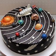 a birthday cake decorated with space and planets