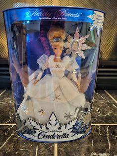 a glass container with a barbie doll in it