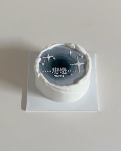 a white cake with blue icing and stars on it