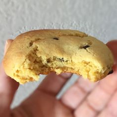 a person holding a half eaten cookie in their hand