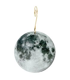 an ornament shaped like the moon with a hook hanging from it's side