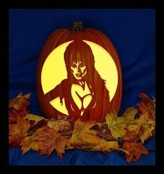 a carved pumpkin with a woman's face on it and leaves surrounding it in front of a blue background