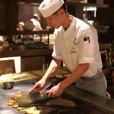 a chef is preparing food in the kitchen