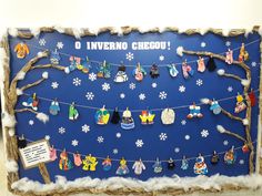 a bulletin board with clothes hanging from it's sides and snowflakes on the bottom