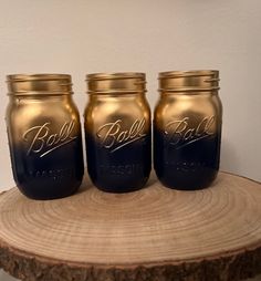 three mason jars sitting on top of a wooden table