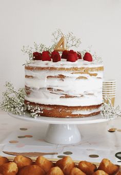 a cake with white frosting and strawberries on top