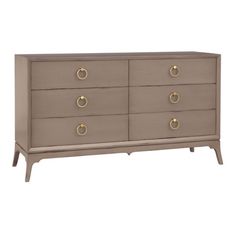 a grey dresser with gold handles and drawers