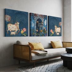 a living room with two paintings on the wall