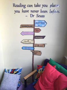 a child's bedroom with a wall painted on the wall and a sign that says reading can take you place you have never been before dr seuss