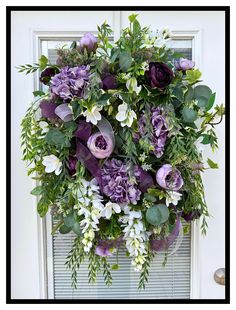 a bouquet of flowers is hanging on the front door