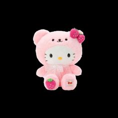 a pink hello kitty stuffed animal with a strawberry on it's head, sitting in front of a black background