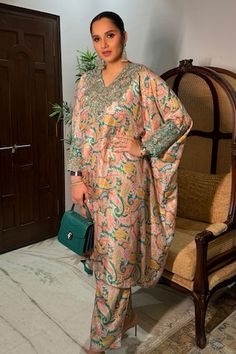 Rama green kaftan with all over vintage print, resham, zardozi applique embroidered V neck and sleeve cuffs. Paired with printed straight fit pant.
Components: 2
Pattern: Printed and Applique Embroidered
Type Of Work: Vintage Print, Resham and Zardozi Work
Neckline: V Neck
Sleeve Type: Batwing Sleeves
Fabric: Pure Silk
Color: Green
Other Details: 
Cut work hem details
Asymmetric hem on kaftan
Inner trim panel
Occasion: Mehendi and Haldi,Sangeet - Aza Fashions Mrunalini Rao, Green Kaftan, Zardozi Work, Straight Fit Pants, Silk Kaftan, Kinds Of Clothes, Designs For Dresses, Fashion App, Green Silk