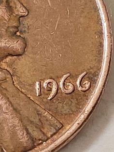 a close up of a penny with the word 1960 on it's side and an image of a man in profile