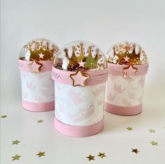 three small pink and white boxes with gold stars on the top one is filled with confetti