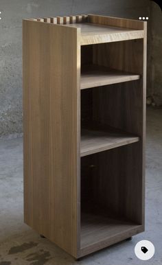 a wooden shelf with three shelves on one side and an open door on the other