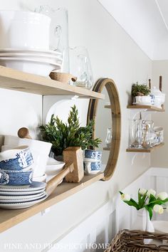 the shelves are filled with dishes and vases