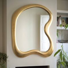 a mirror that is on the wall above a fireplace