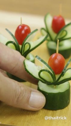 cucumber and tomato appetizers with toothpicks on them