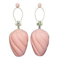 two pink vases with metal handles on white background