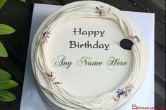 a white birthday cake sitting on top of a card