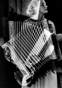 a woman holding an accordion in her hands