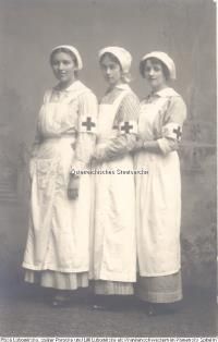 an old photo of three women dressed in nurses'uniforms with cross on their shoulders