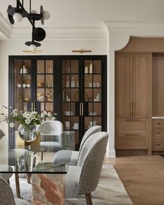 a dining room with chairs and a glass table