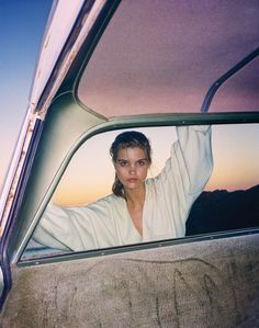 a woman sitting in the passenger seat of a car